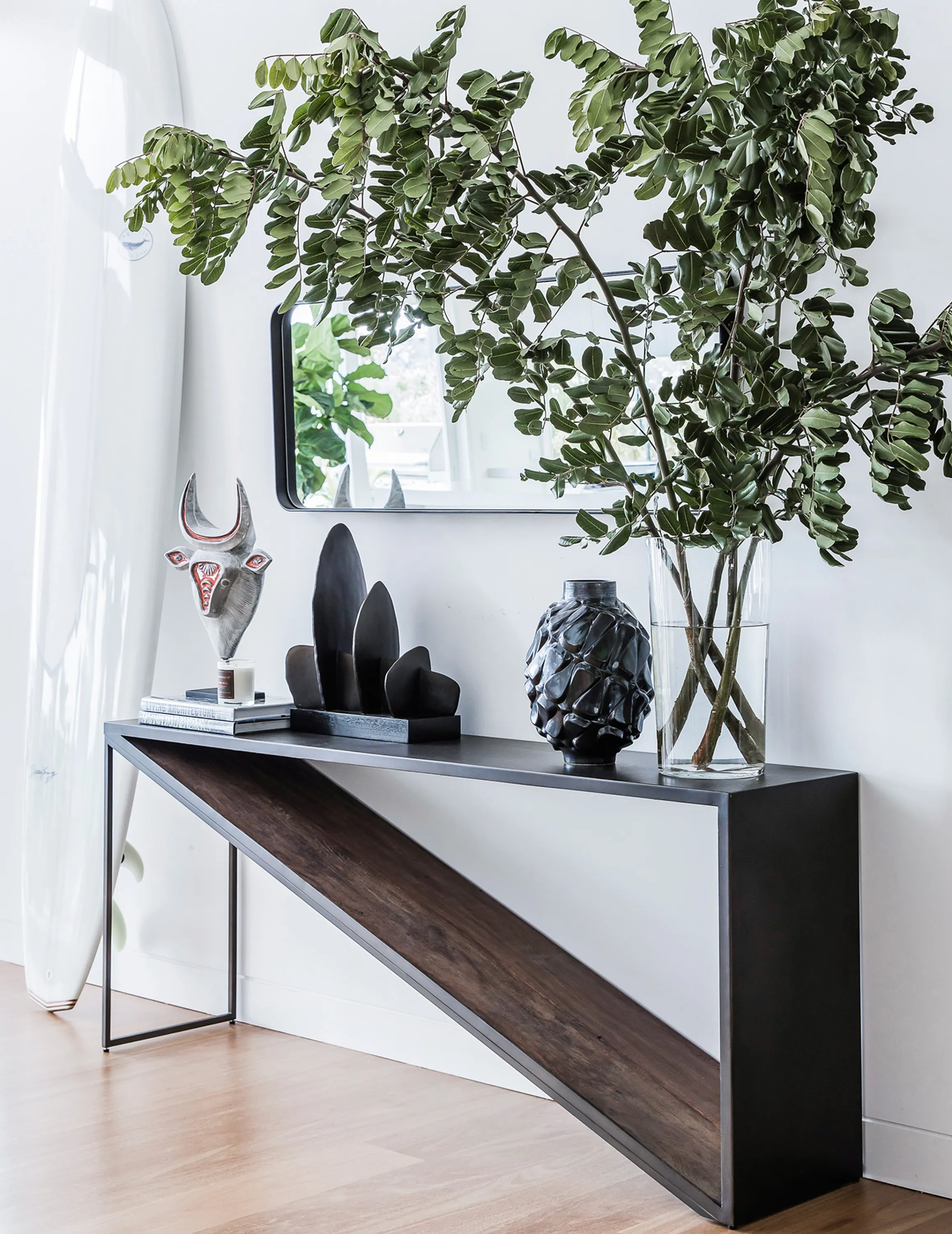 Airy entryway with huge branches as décor.