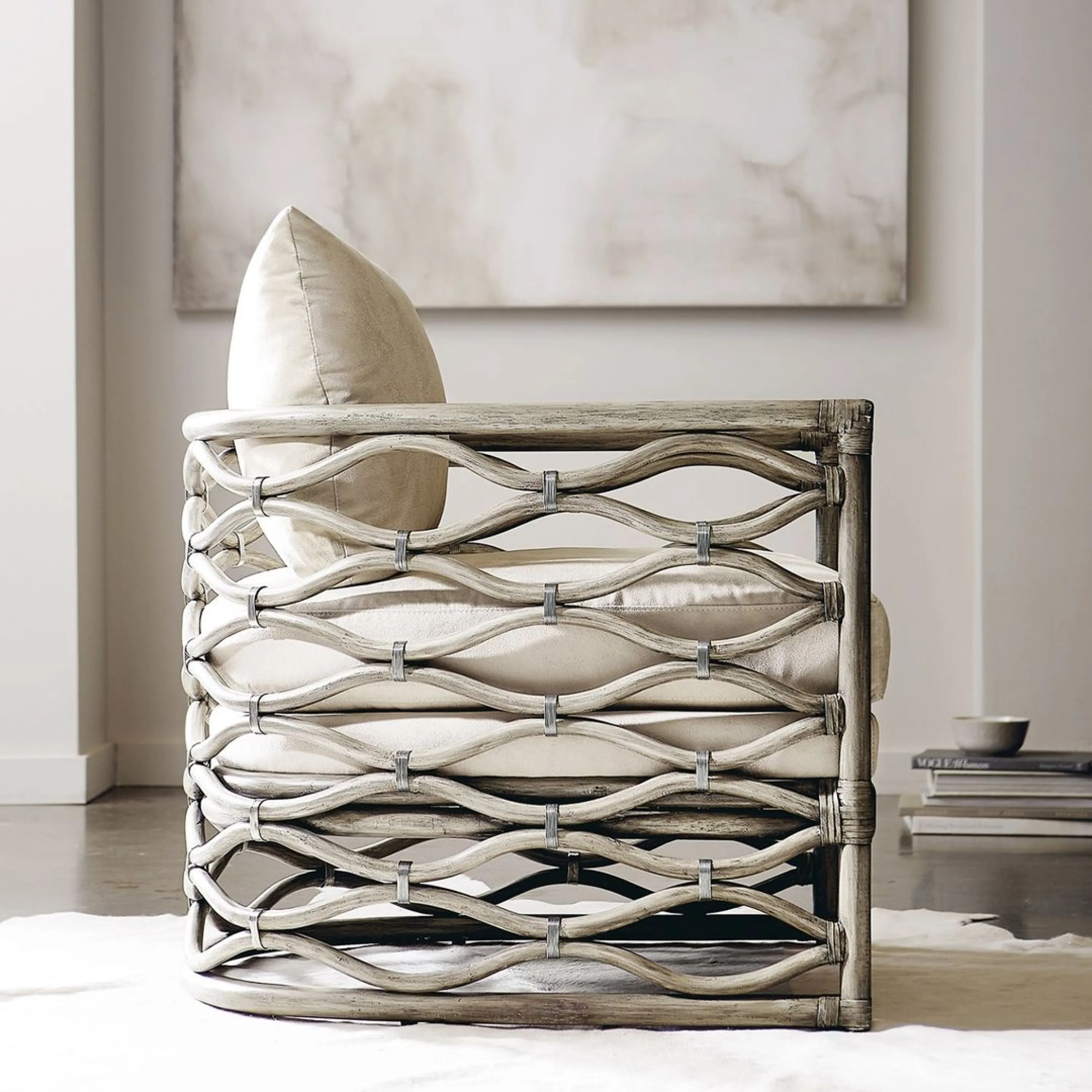 Neutral armchiar with a wavy detailing that catches the light.