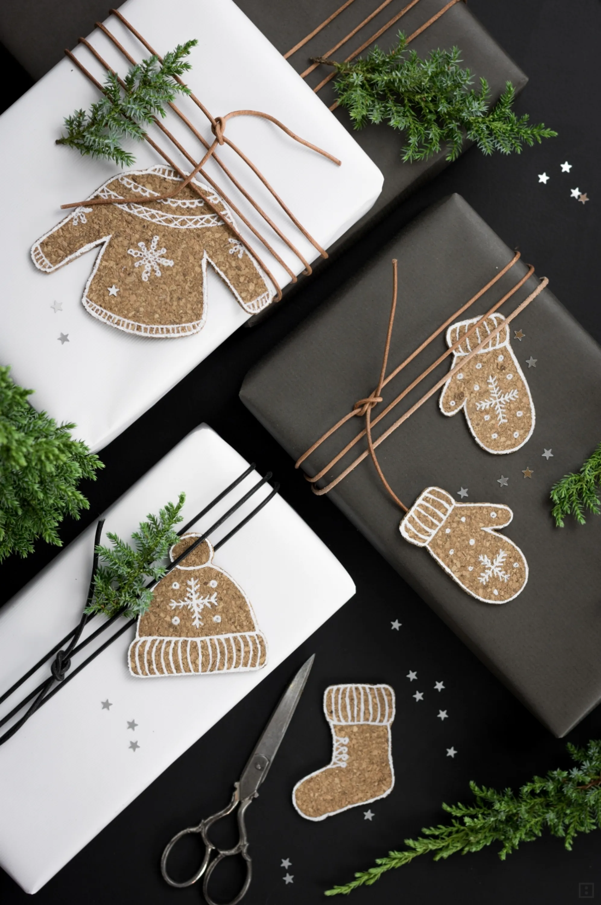 White and black paper decorated with cork ornaments.