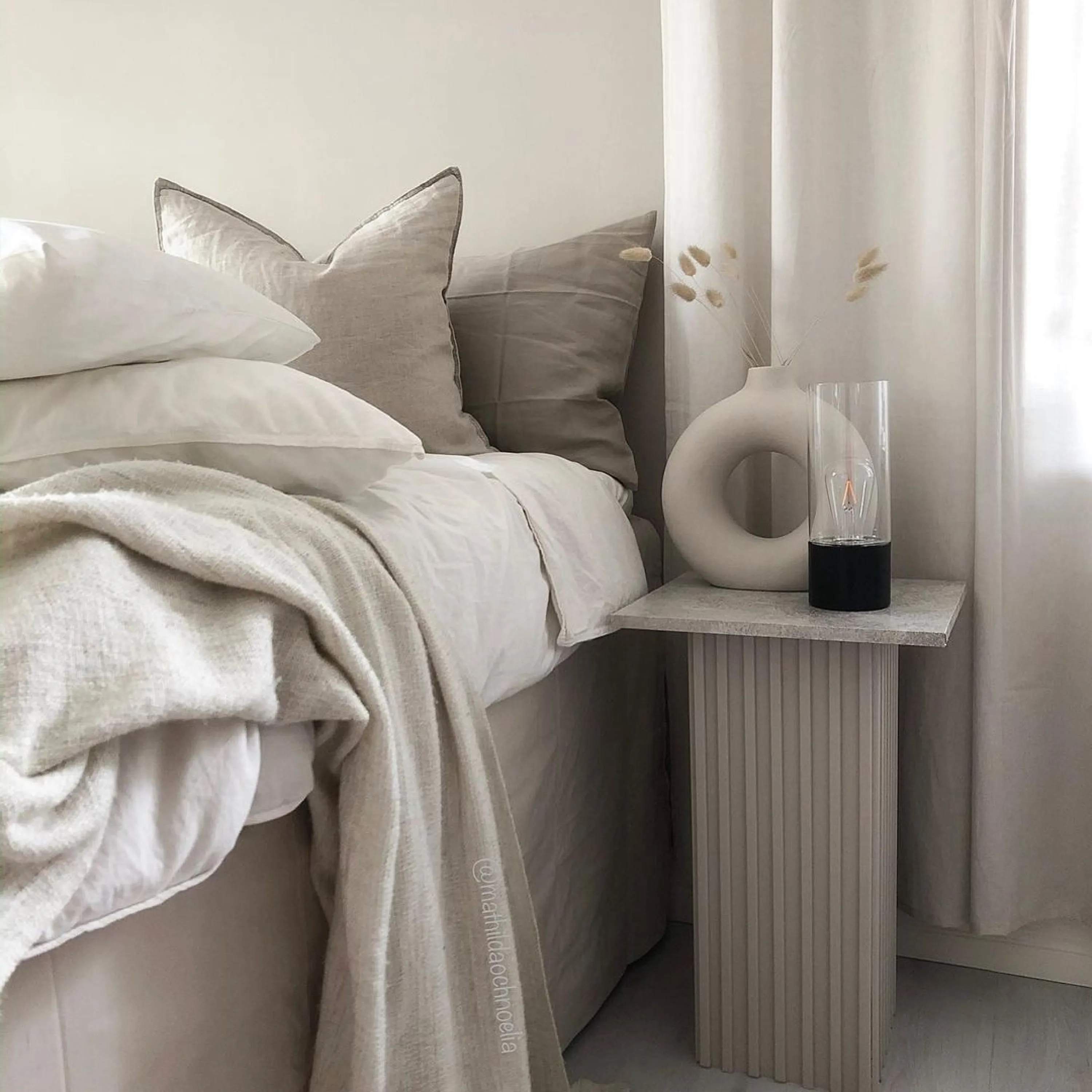 Neutral bedroom with juxtaposed textiles in the same colours.