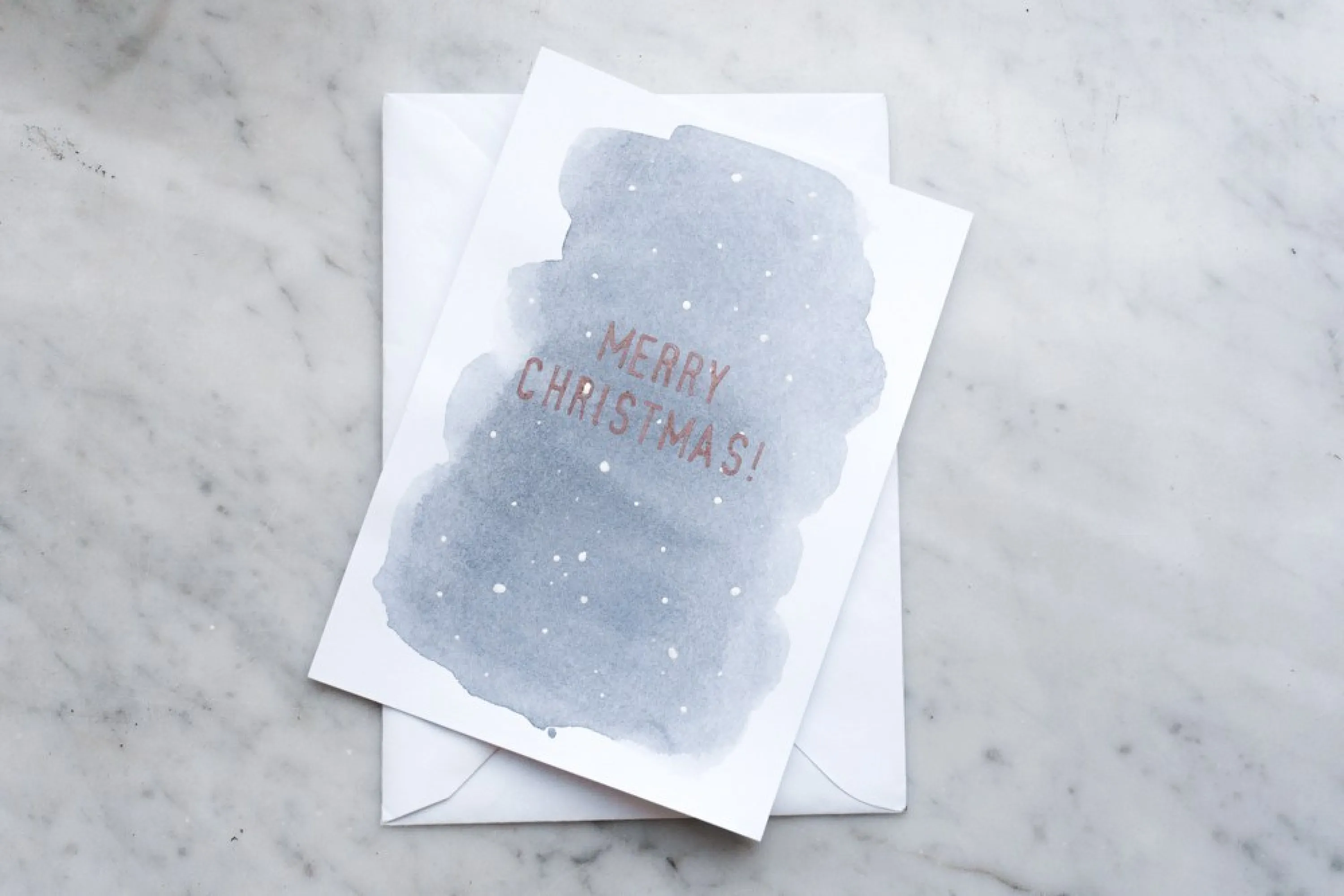 Christmas card with a watercolour background and a simple "Merry Christmas" writing.