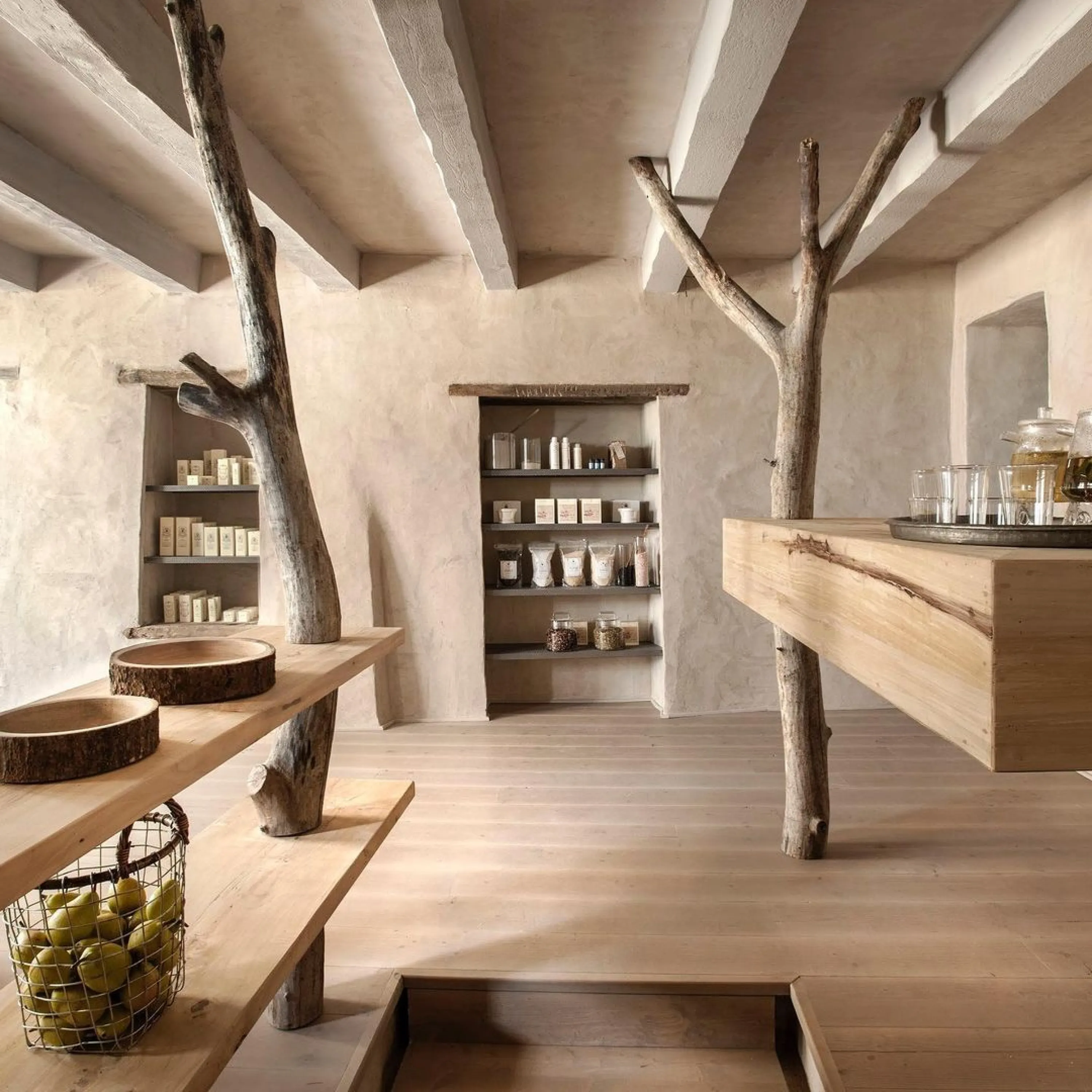 Real tree branches used as columns in a retail interior.