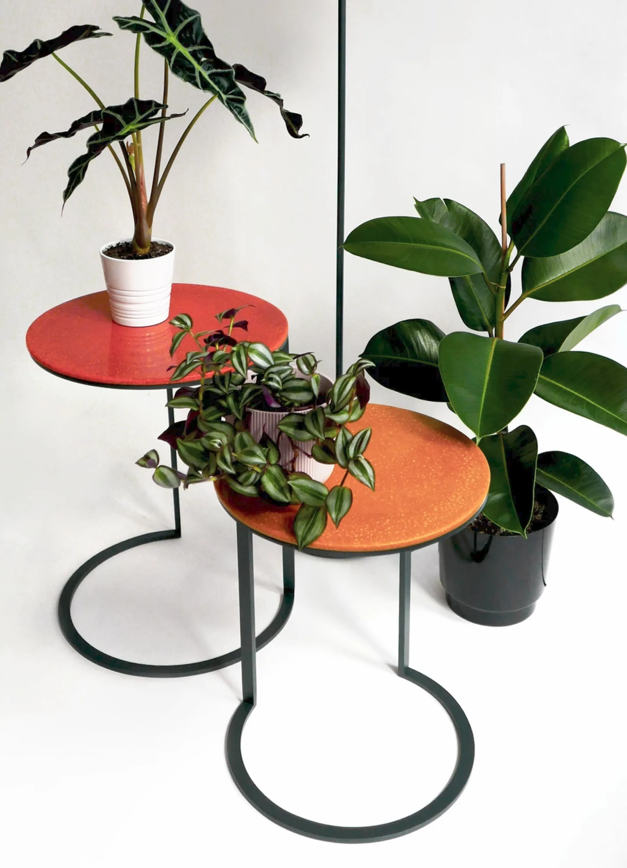 Side tables with metal structure and bright orange top made of lentil pulp.