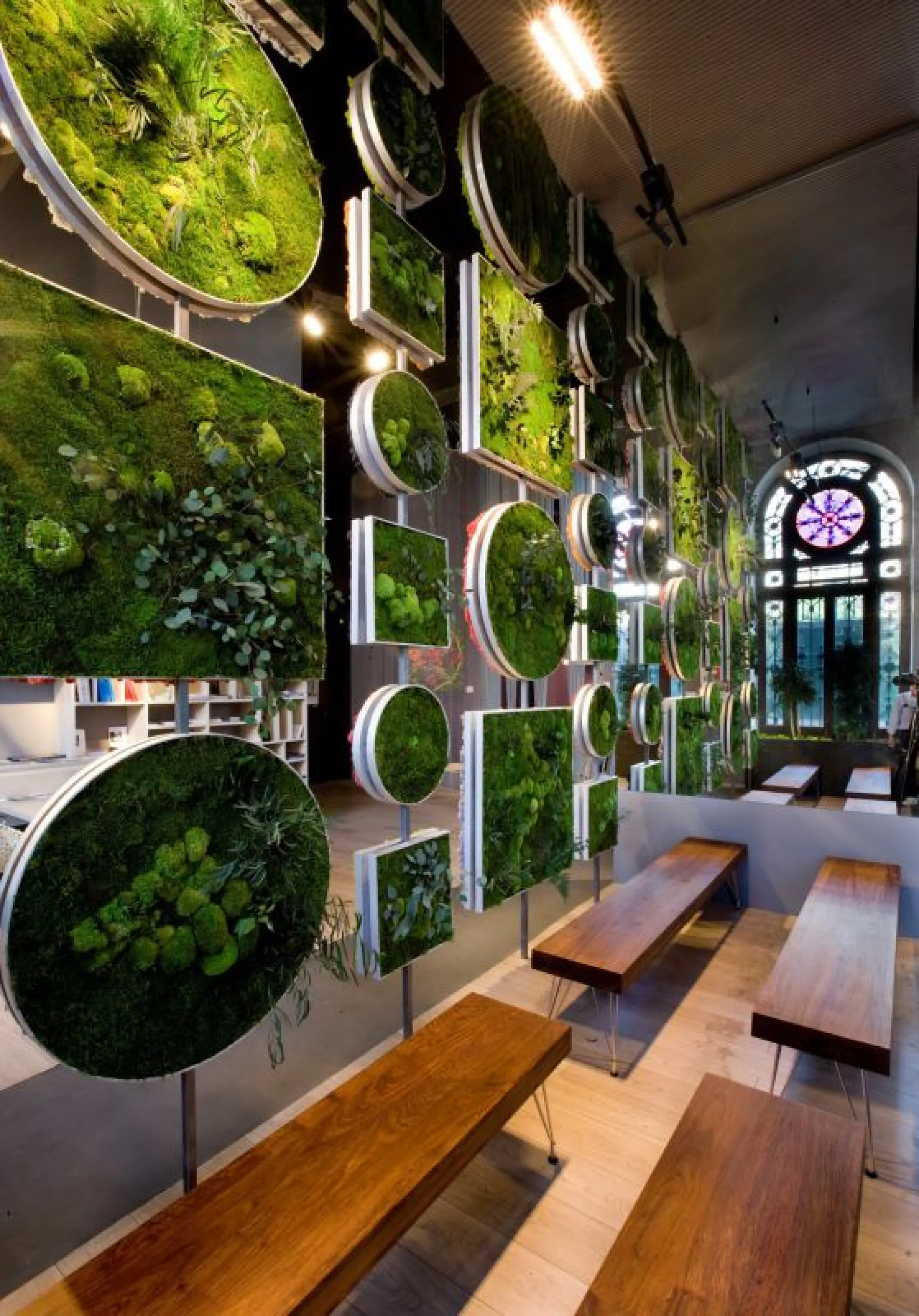 Floor-to-ceiling room divider made with frames filled with moss.