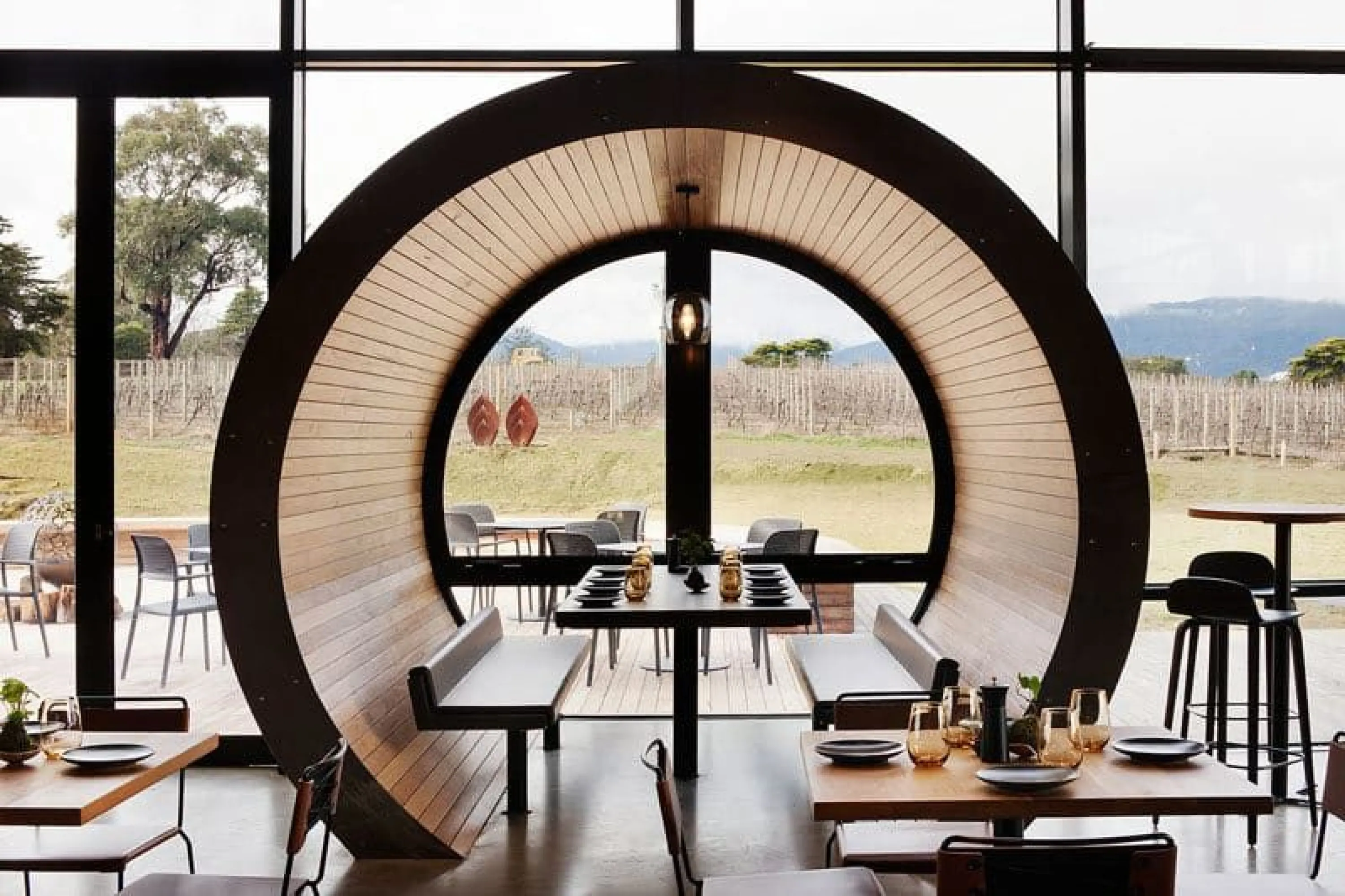Restaurant table enclosed in a rounded wood structure.