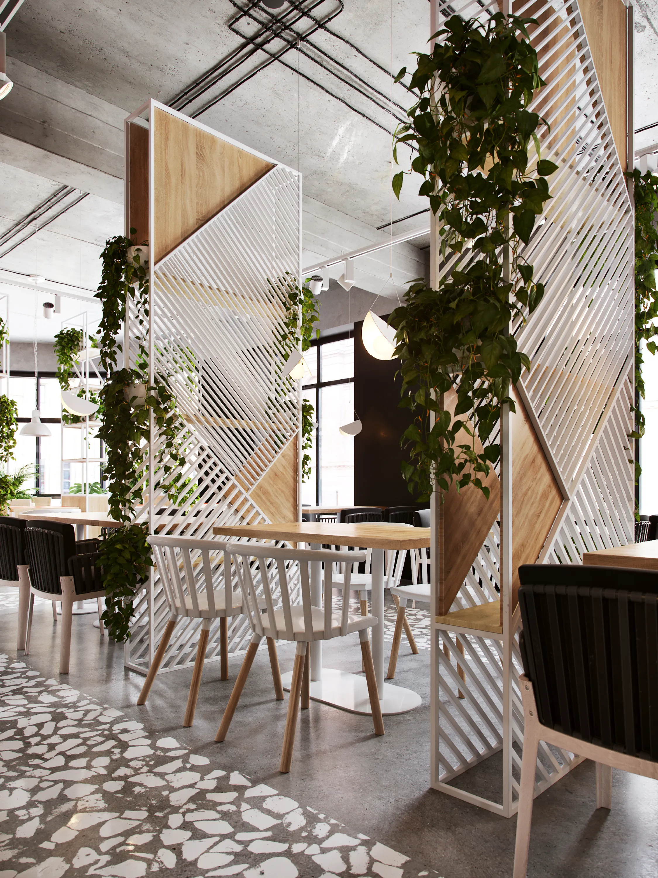 Restaurant tables separated with tall room dividers filled with plants.