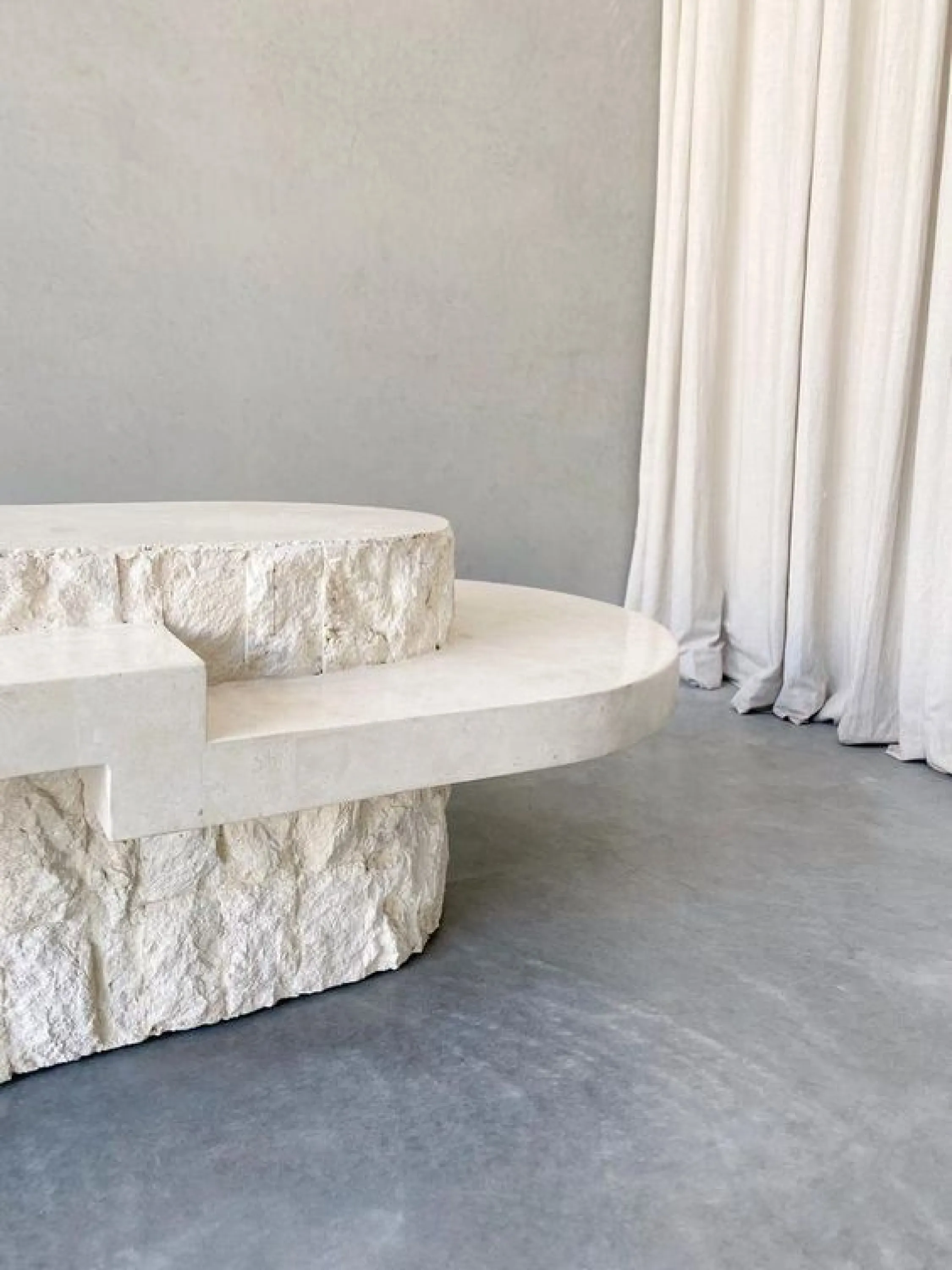 Stone coffee table with rough base.
