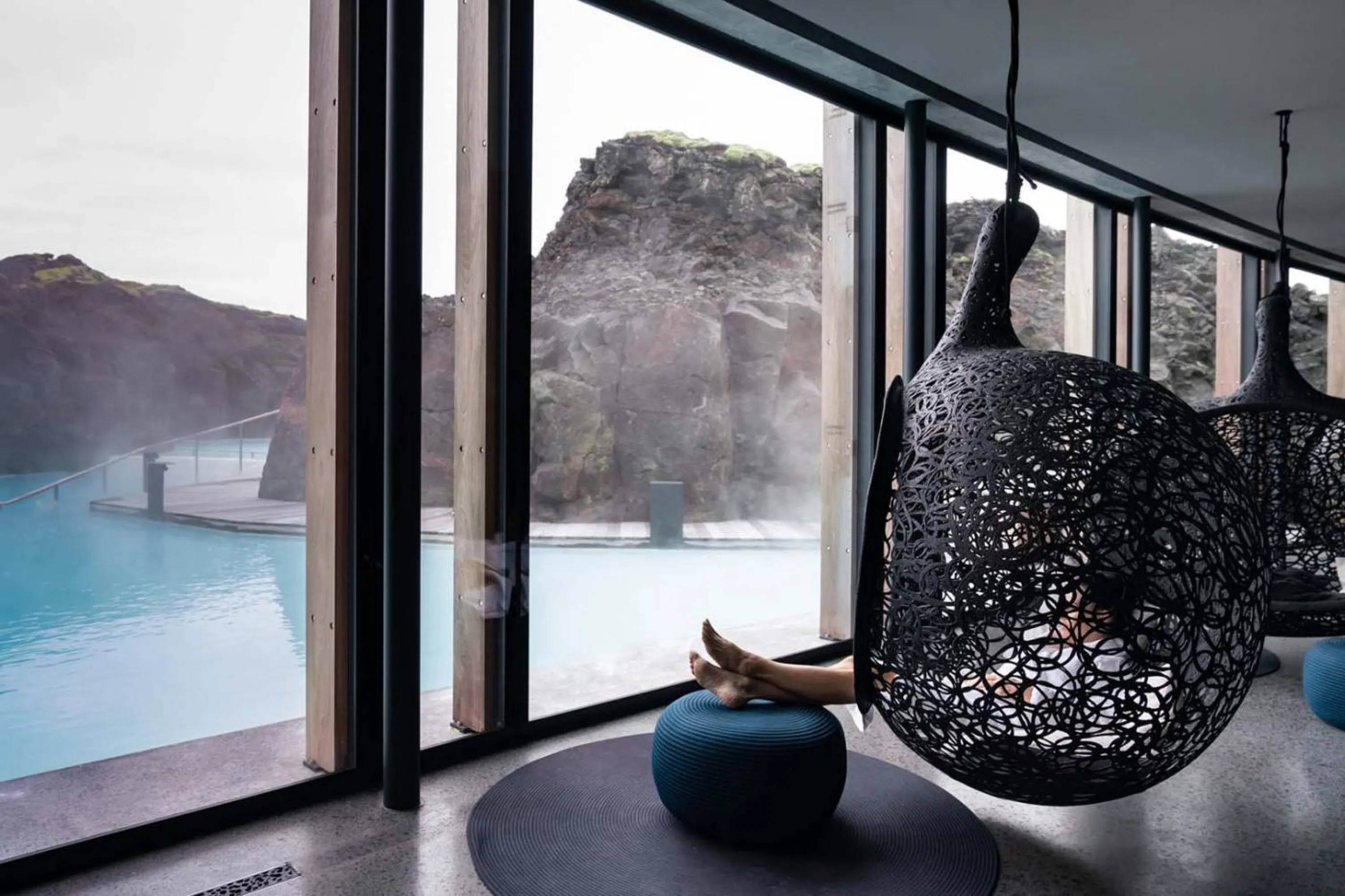 Hanging chairs looking into a beautiful thermal pool.