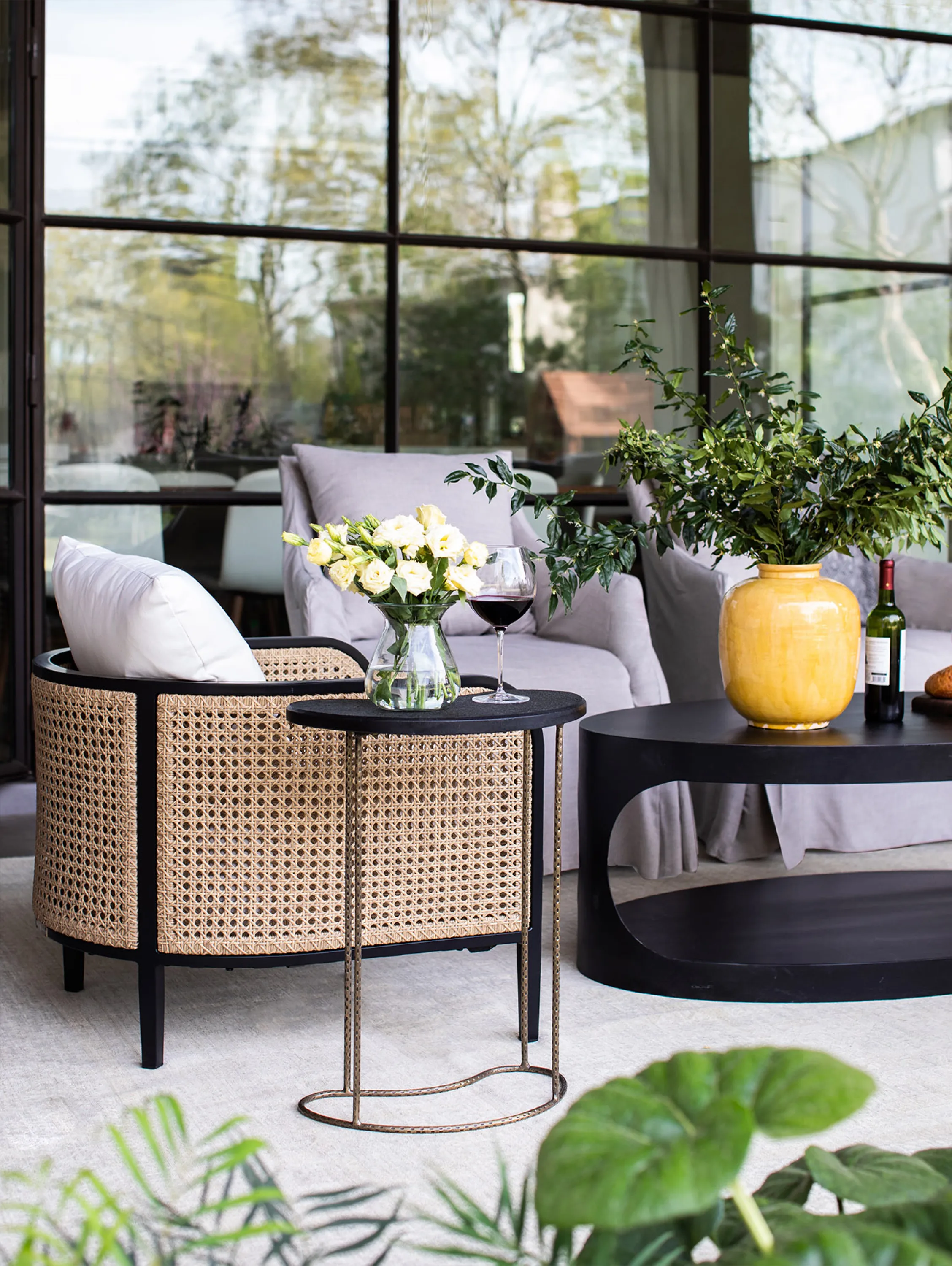 Outdoor seating area with a rattan armchair.