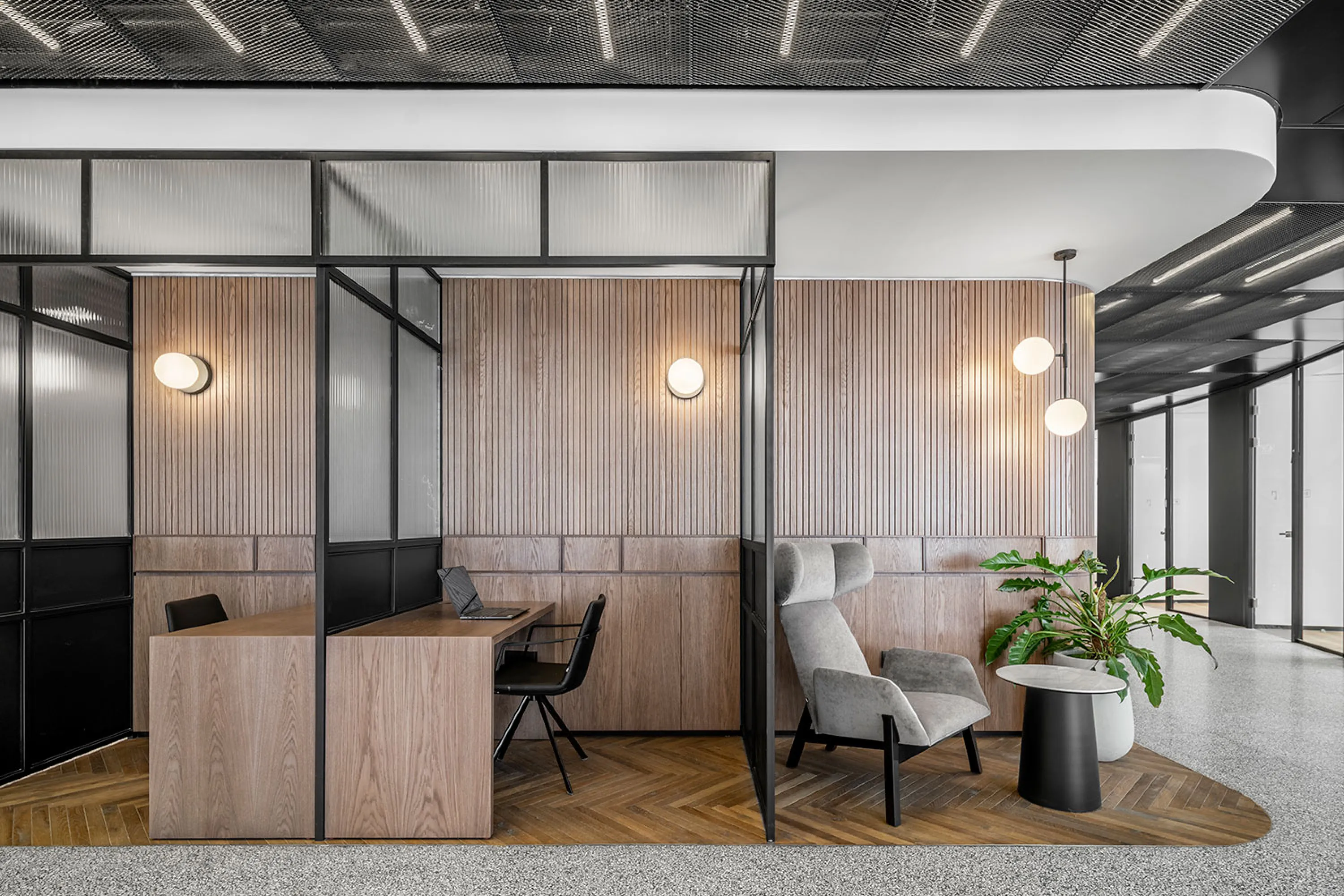 Individual workstations separated with glass panels.