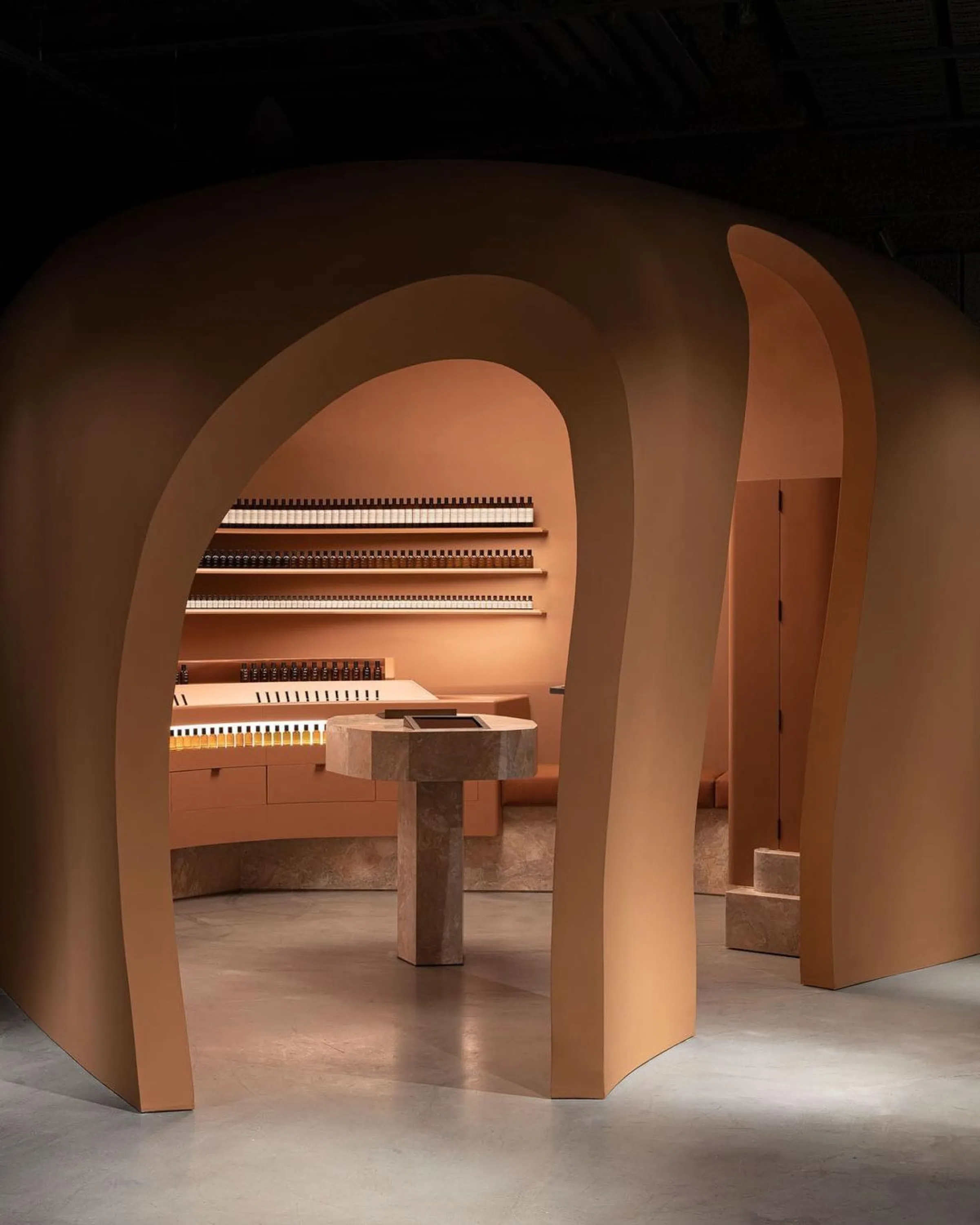 Curved doorway enclosing a small area in a shop interior.
