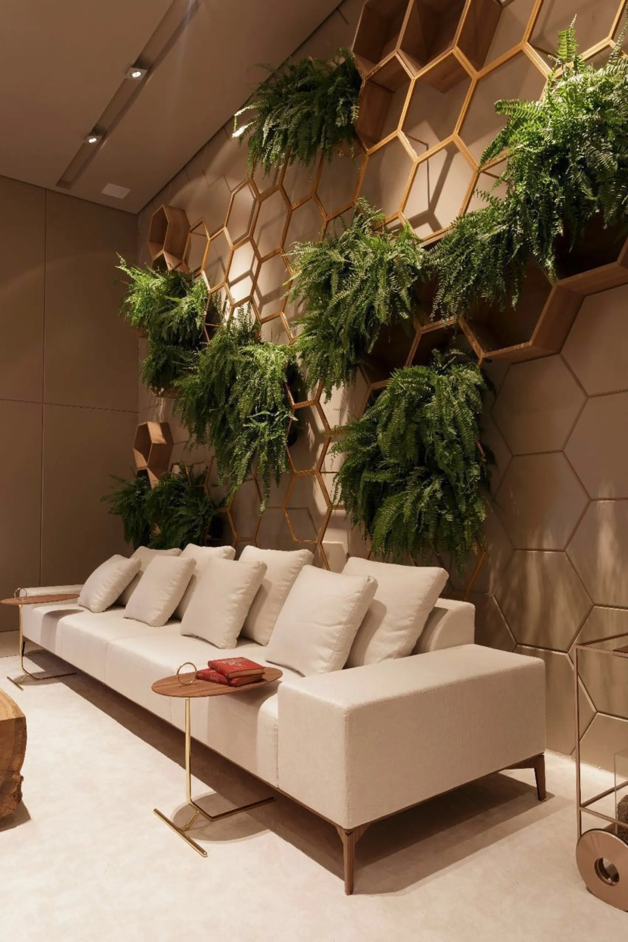 Draping plants into hexagonal frames behind a sofa.
