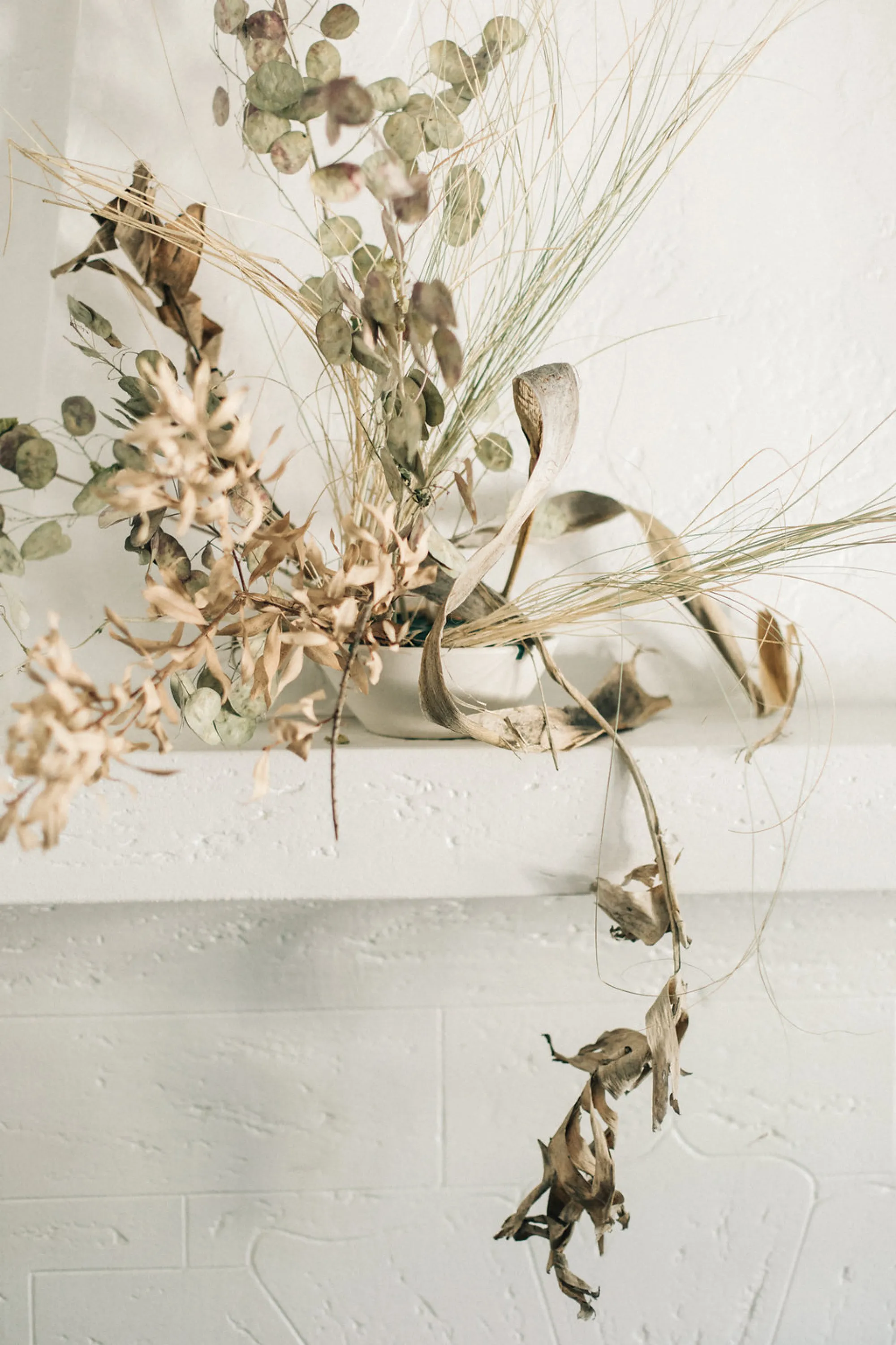 Simple leaves and branches arranged in a drooping arrangement.