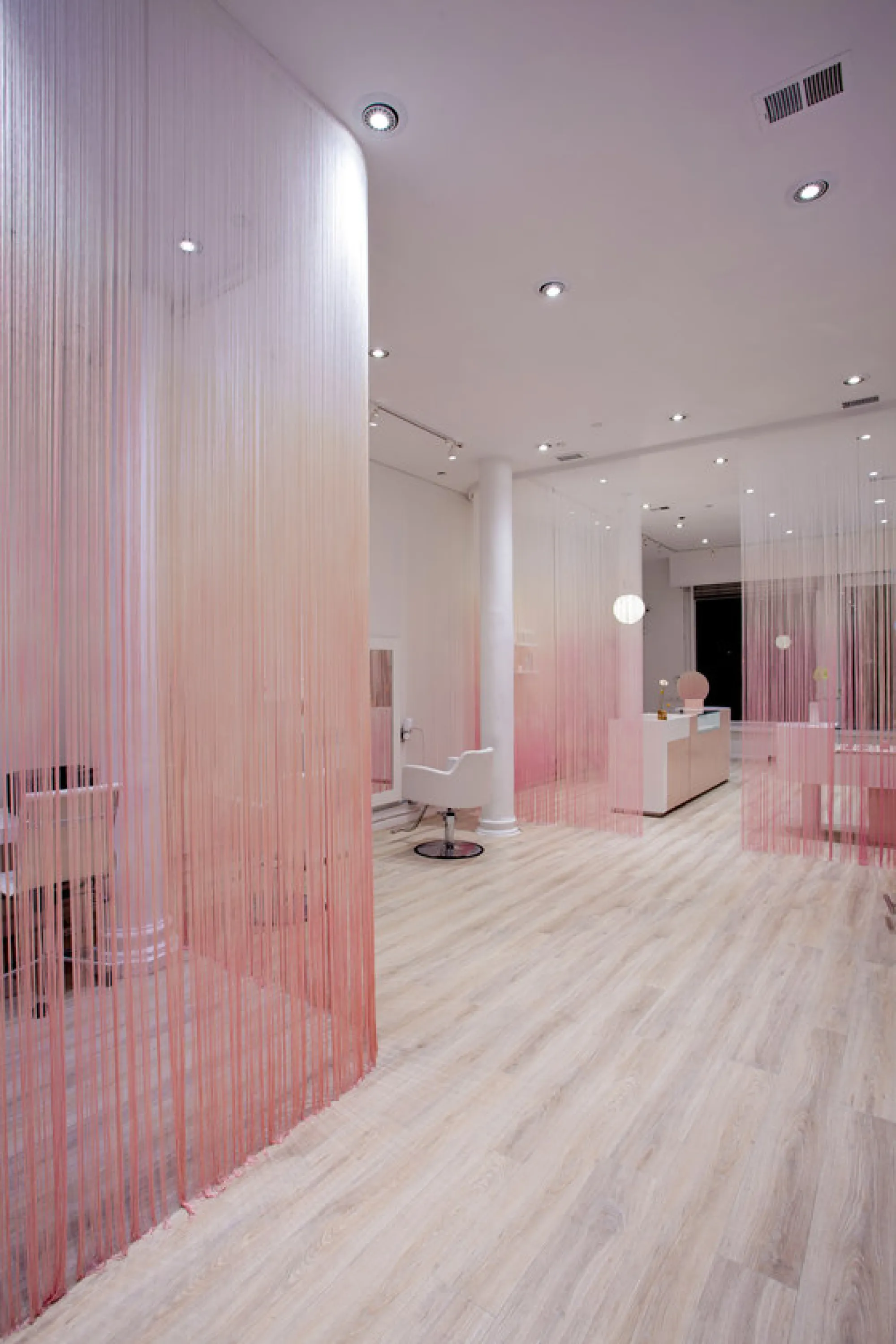 Hair salon partitioned with full height curtains.