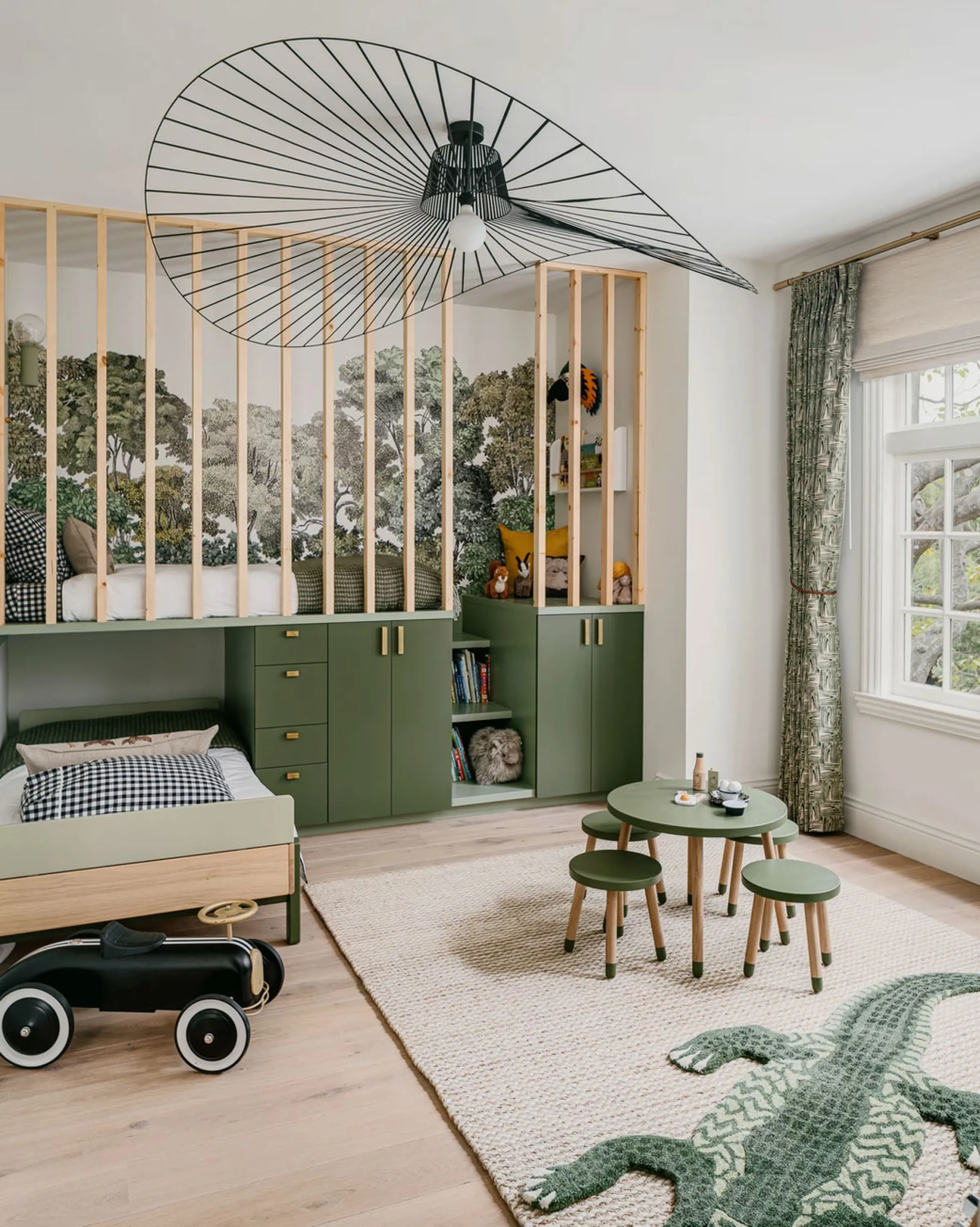 Children's bedroom in the tones of green and light wood.