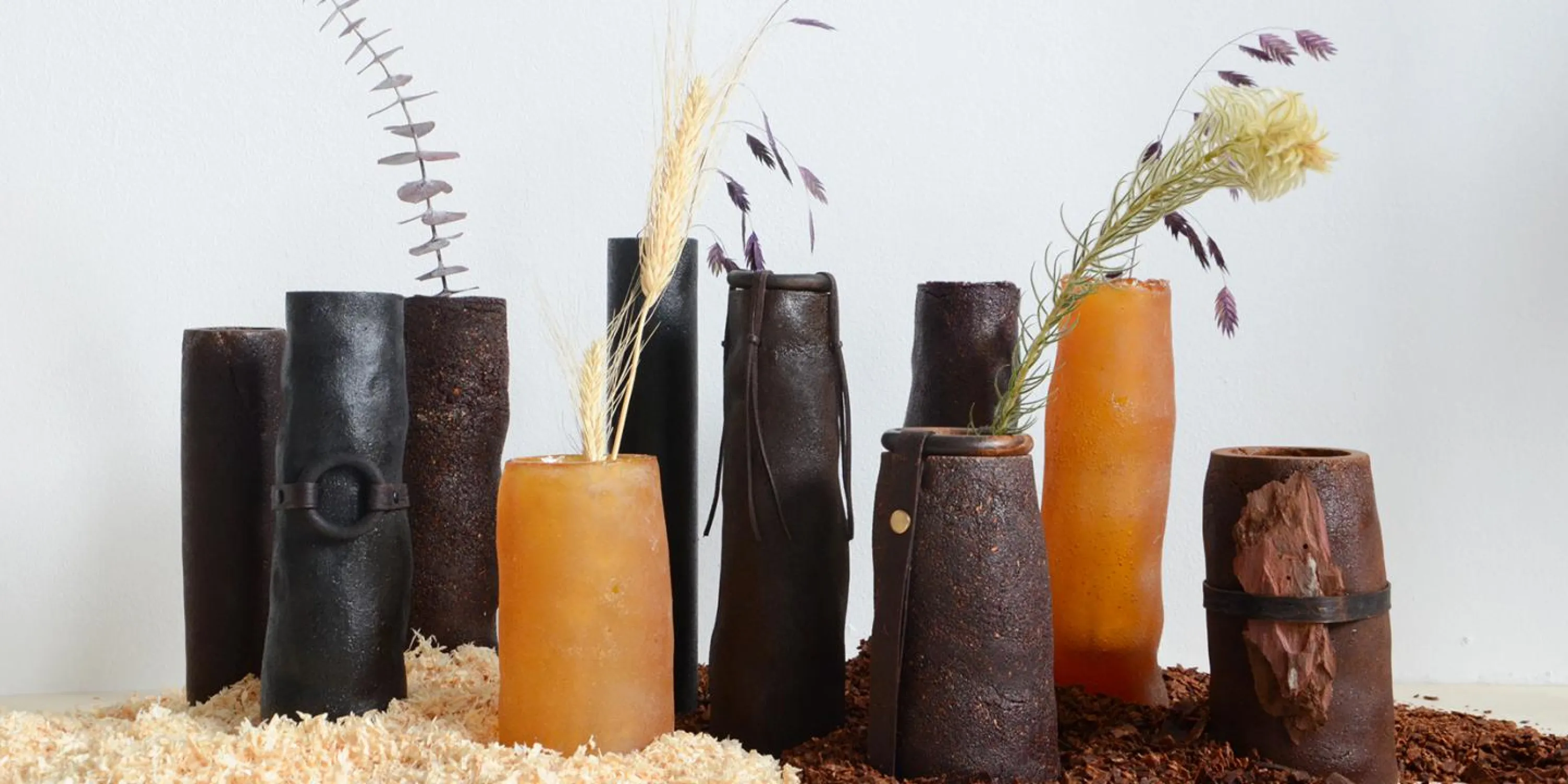 PineResin vases with dried flowers in them.