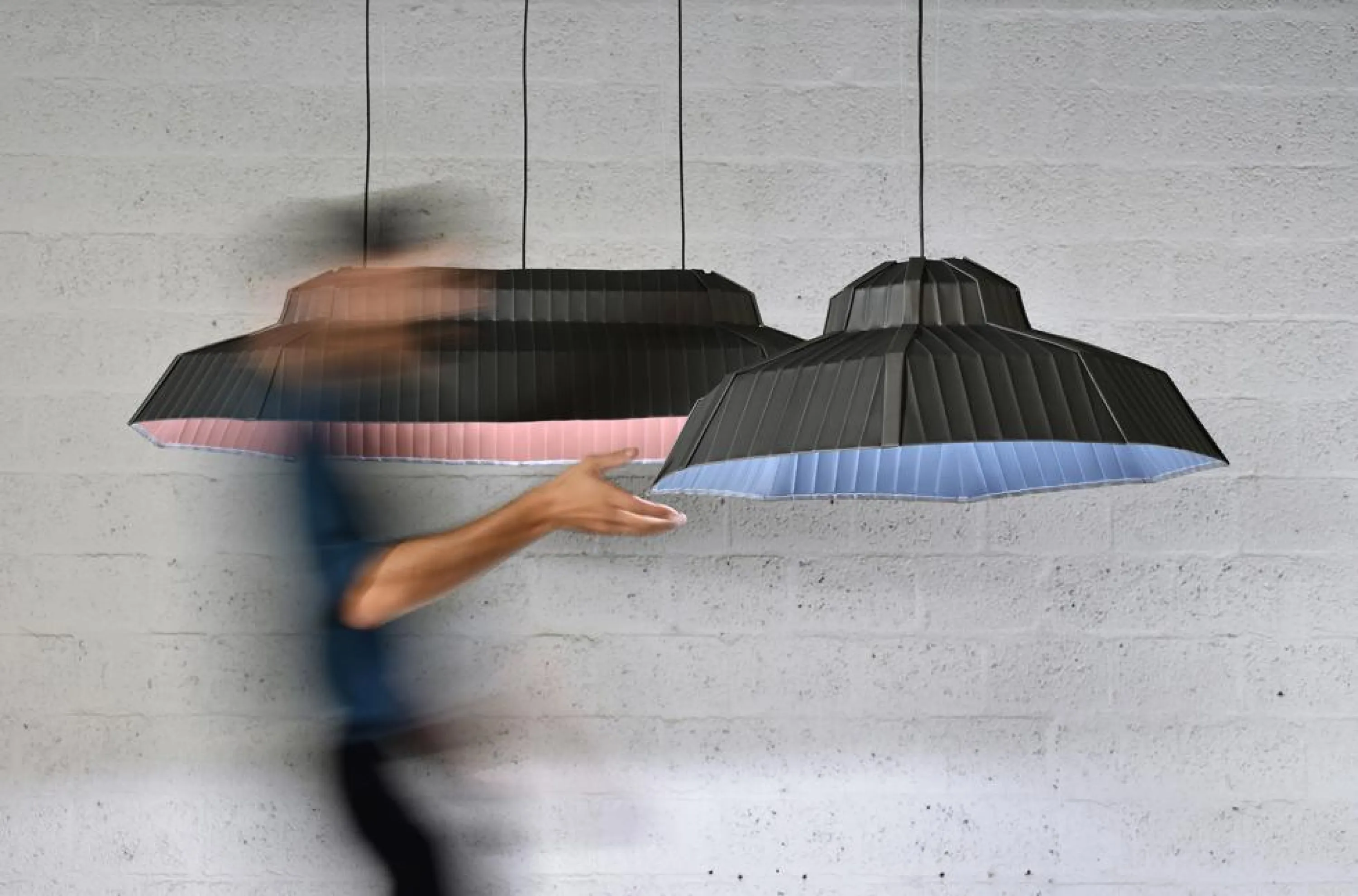 Lampshades recalling the shape of a roof and covered in zinc.