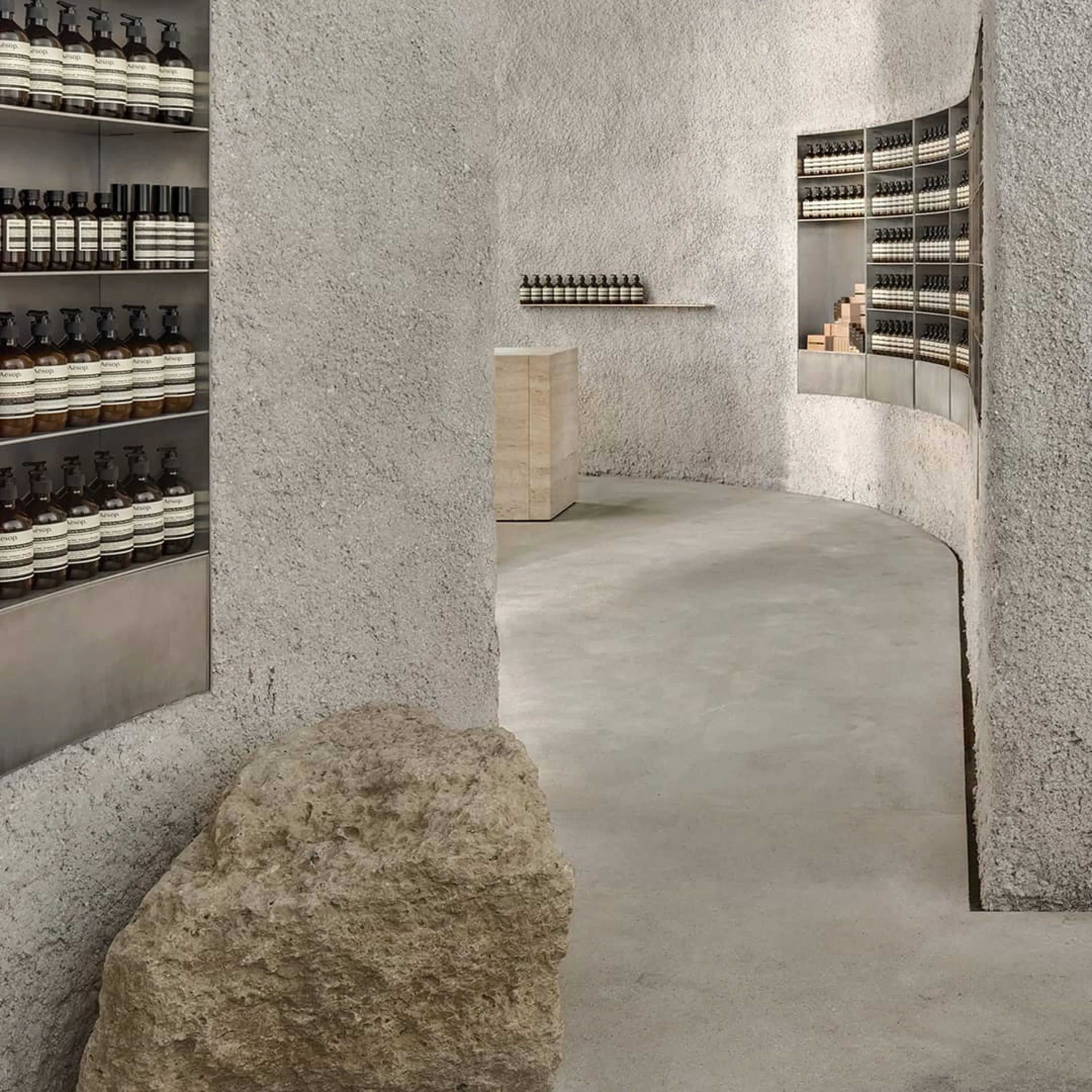 Interior of a store with rough stone surfaces recalling local ecology.