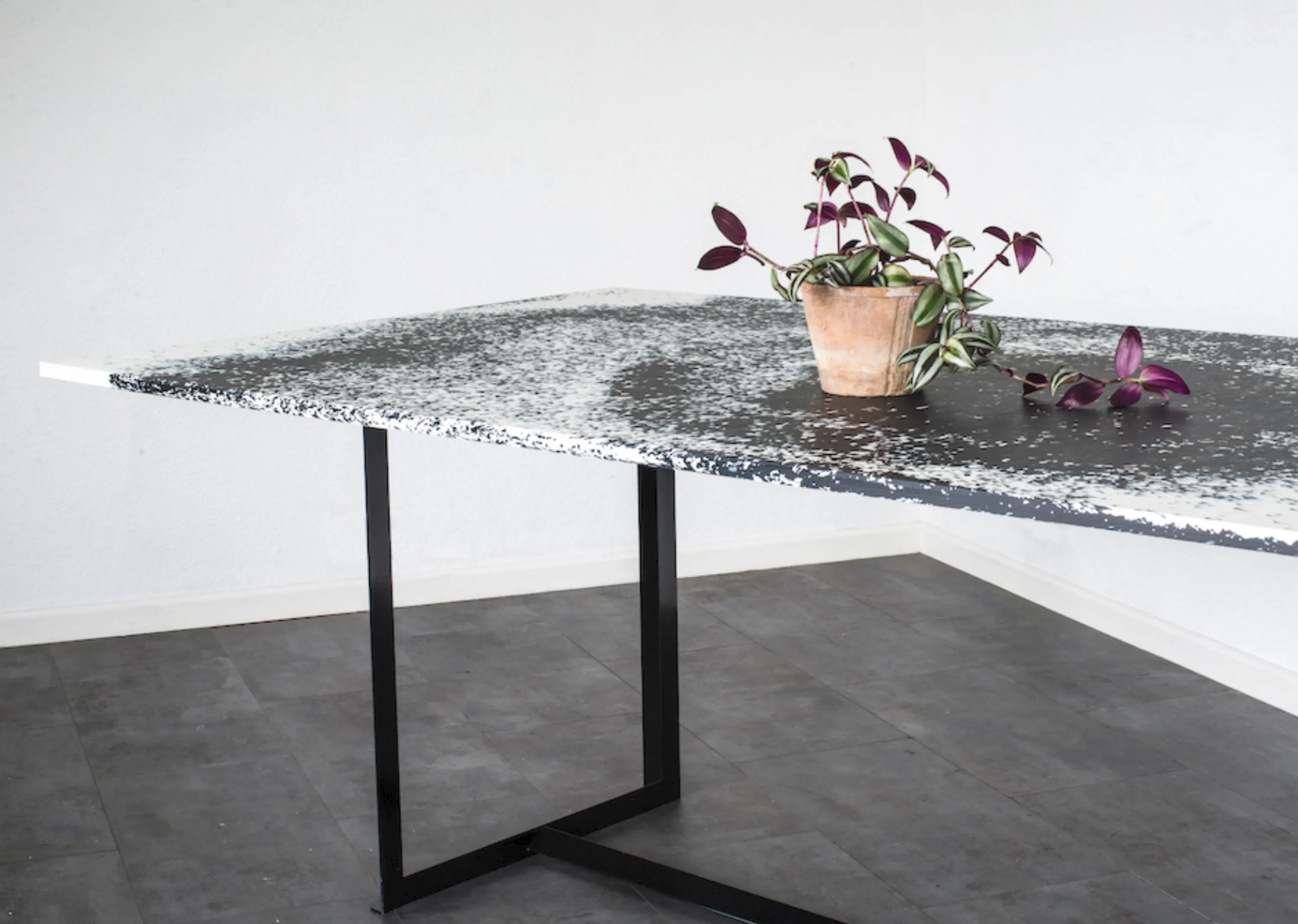 A table whose top is made with a recycled plastic composite.