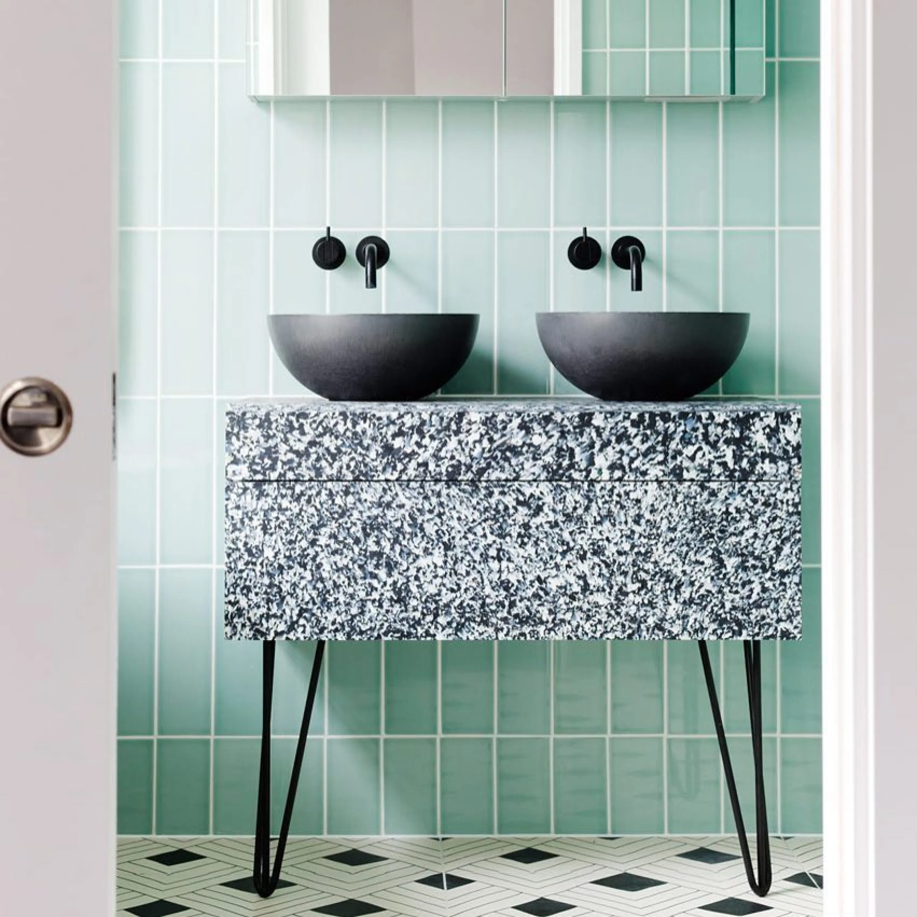 A bathroom vanity made with a recycled plastic composite.