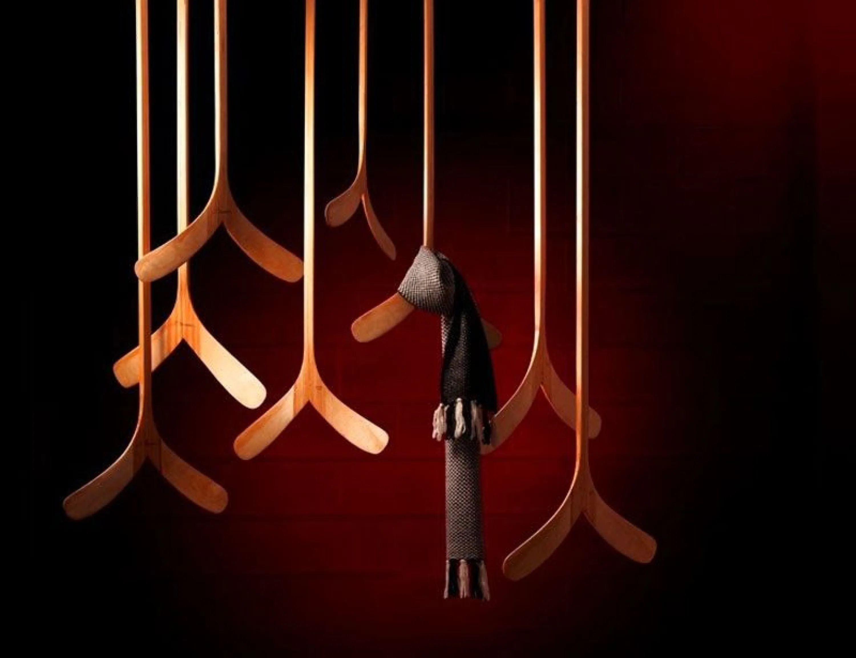 Wooden clothes hangers mounted on the ceiling with organic shape.