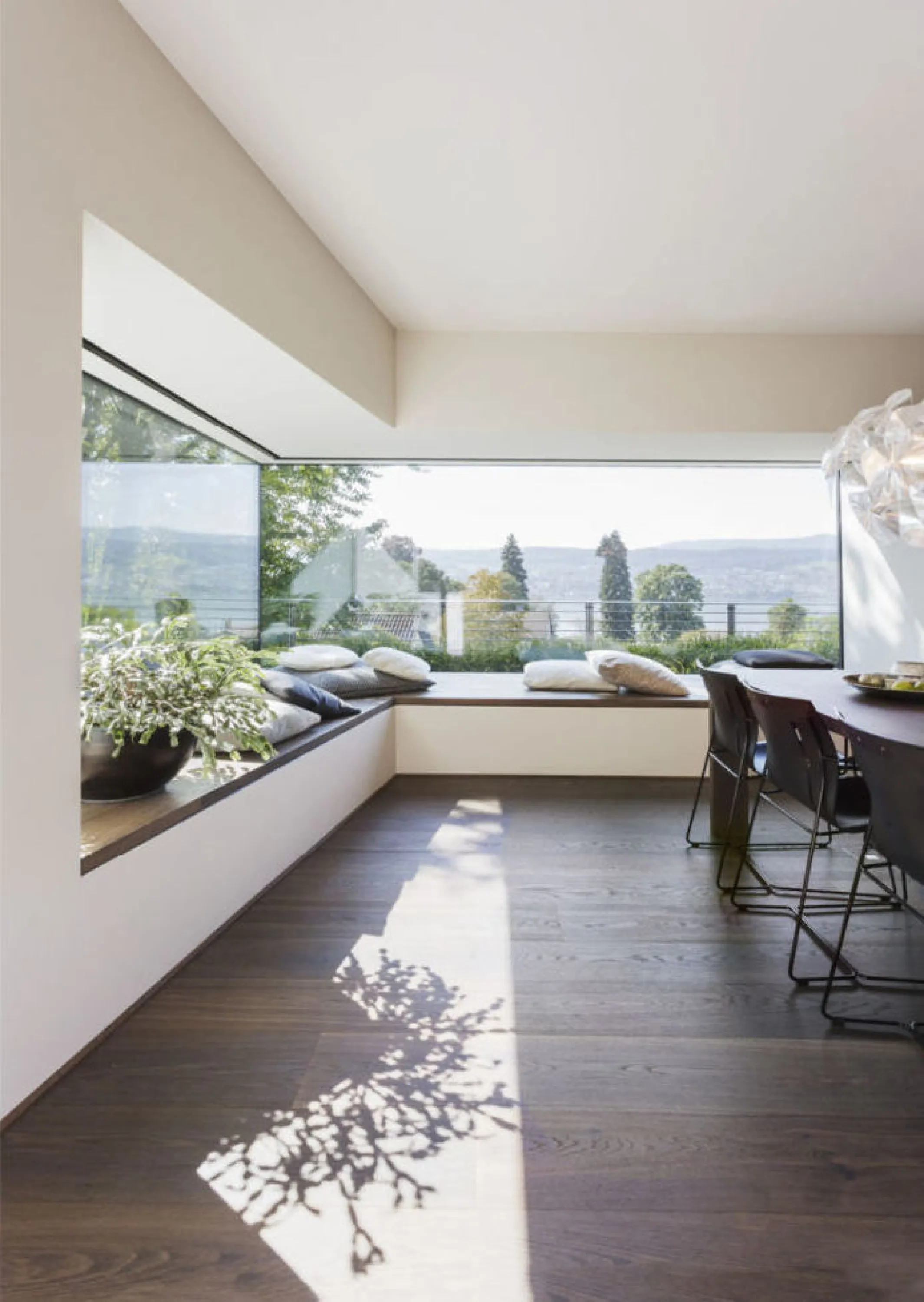 Angular bay window in a modern living room, a great biophilic design example.