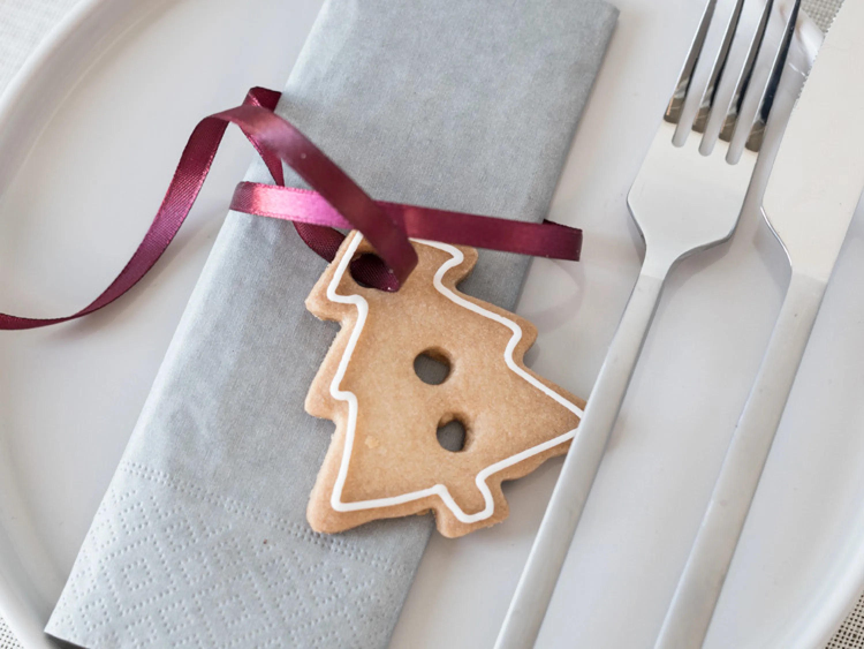 A biscuit tied around a napkin with a satin ribbon.