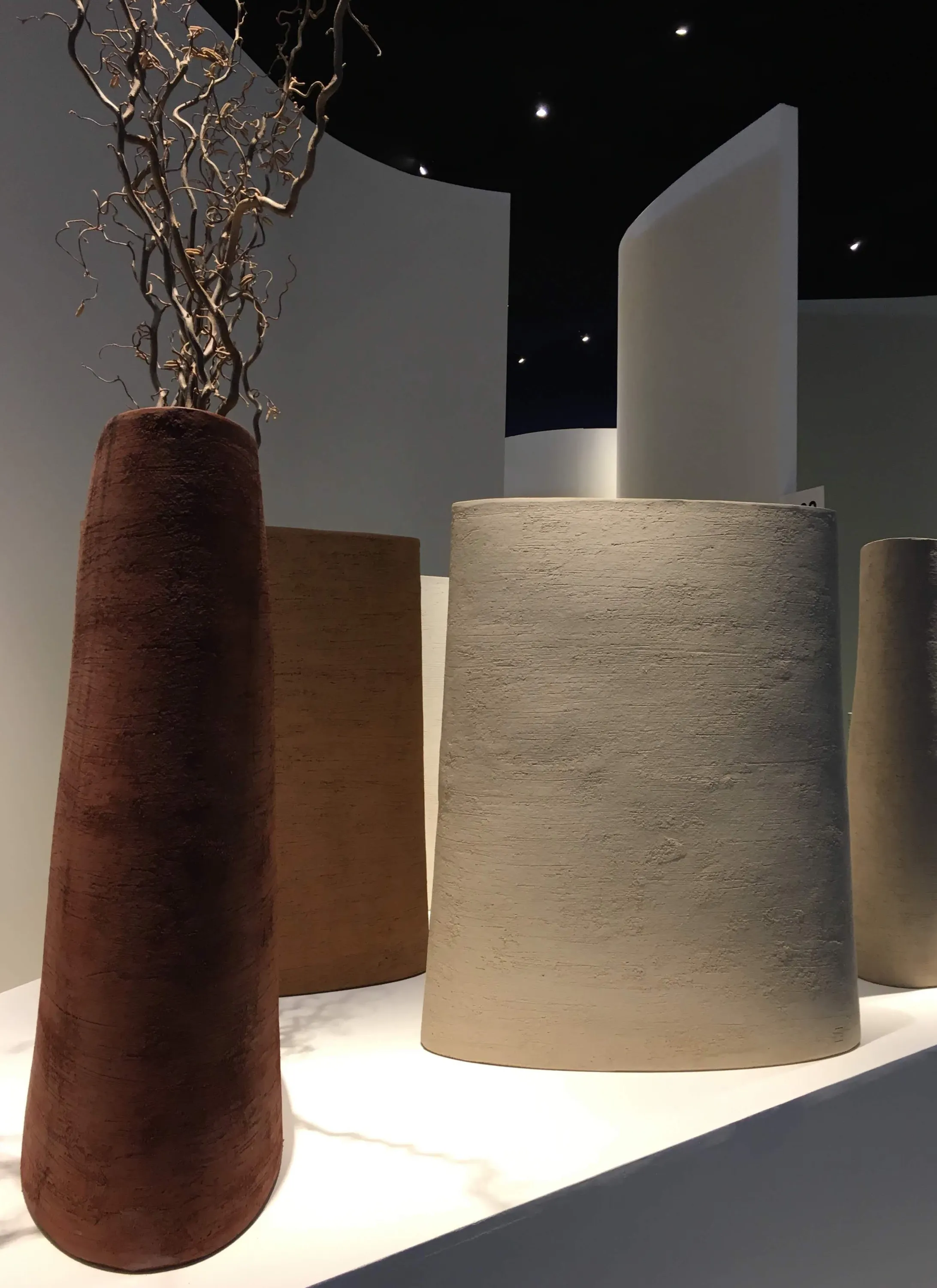 Close-up of the textural planters and tall trees.