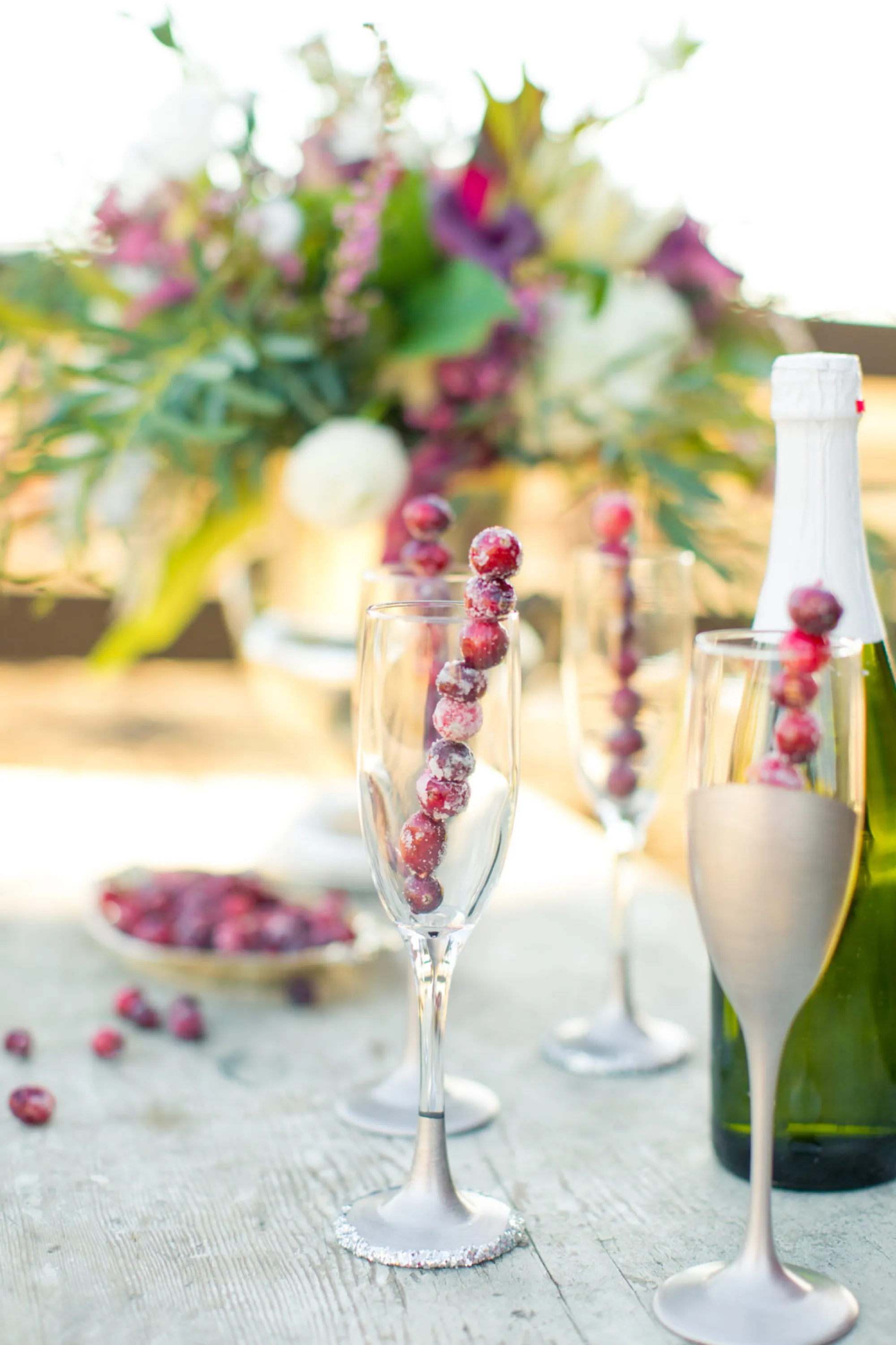 A stick made of frozen cranberries adds a festive vibes when put into a champagne glass.