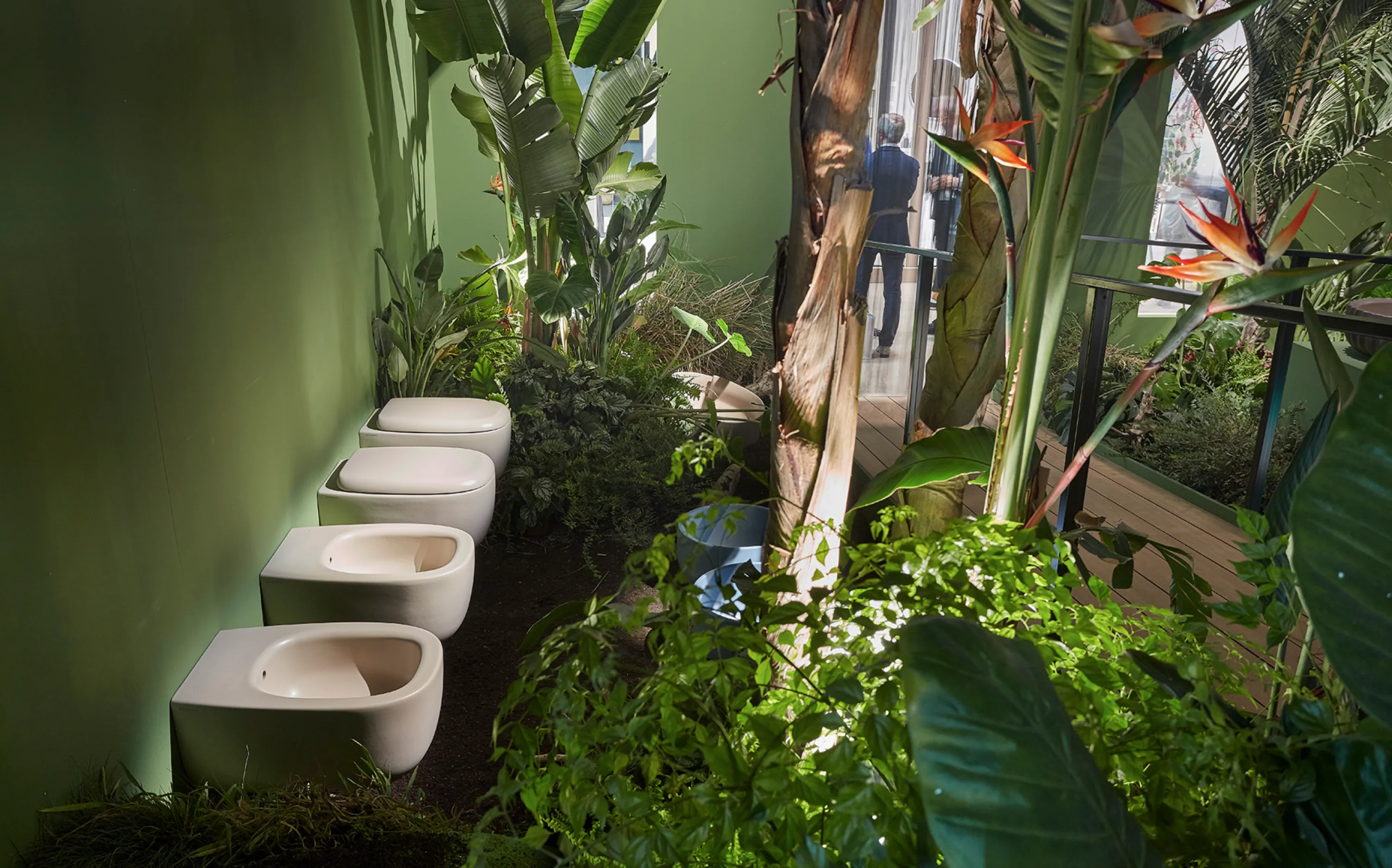 Toilets surrounded by greenery in a jungle-like environment.