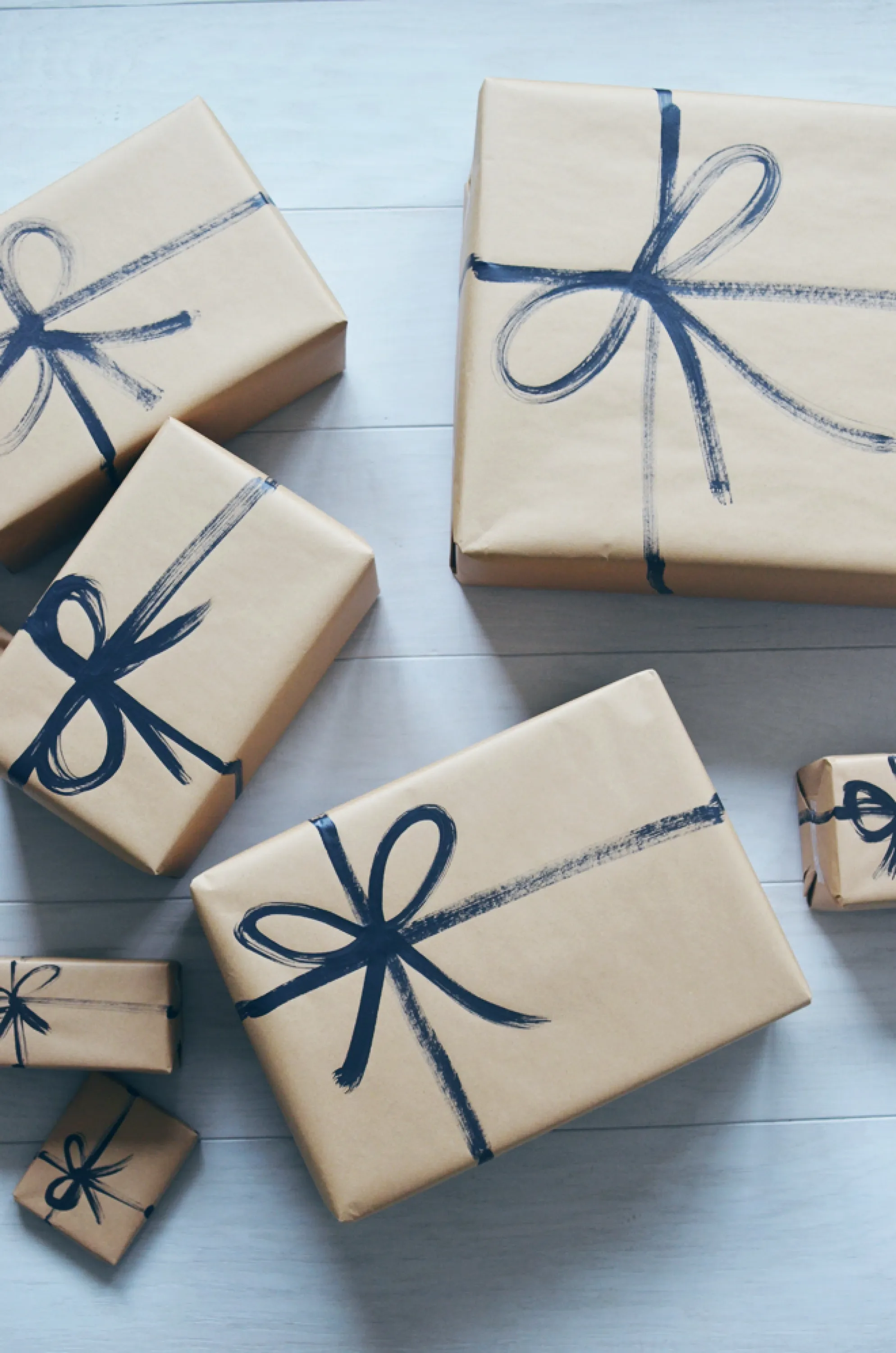 Brown paper gift wrapping with a ribbon drawn over it.