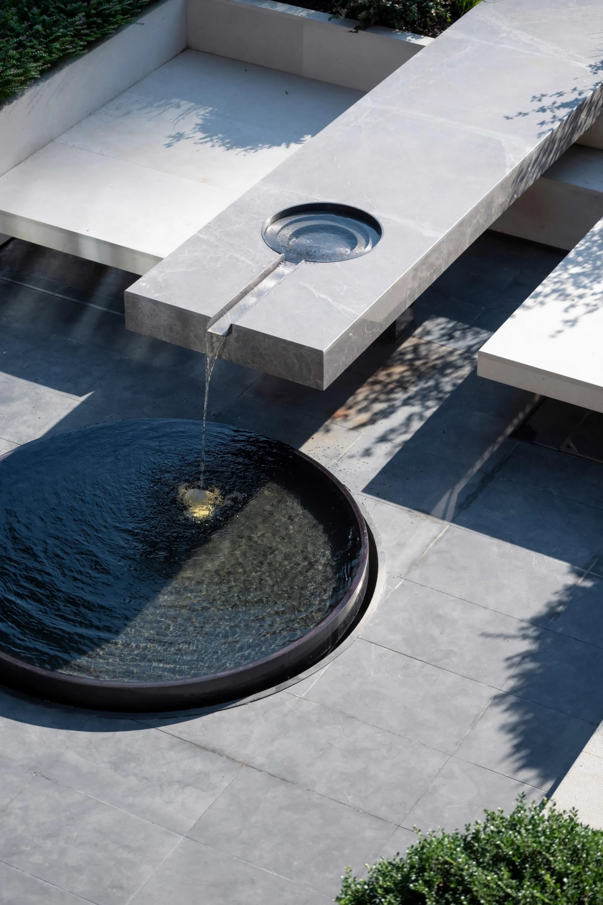 Outdoor seating area integrating a water feature.